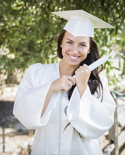 Photo: Graduating Mixed Race Girl In Cap and Gown with Diploma Graduating Mixed Race Girl In Cap and Gown with Diploma