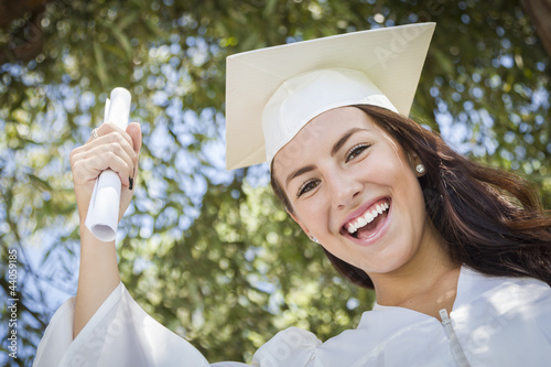 Photo: Graduating Mixed Race Girl In Cap and Gown with Diploma Graduating Mixed Race Girl In Cap and Gown with Diploma