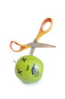 Photo: Granny smith apple murdered by scissor over white background Granny smith apple murdered by scissor over white background