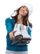 Foto: Young woman showing ice skates for winter ice skating Young woman showing ice skates for winter ice skating