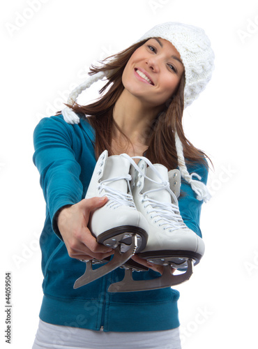 Photo: Young woman showing ice skates for winter ice skating Young woman showing ice skates for winter ice skating