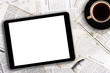 digital tablet and coffee cup on newspapers