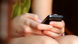 Girl fingers typing on a mobile.