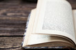 Photo: Aged book on wooden table Aged book on wooden table