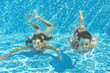 Happy smiling underwater children in swimming pool, kids sport