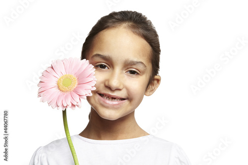 Photo: Girl smiling with pink flower Girl smiling with pink flower