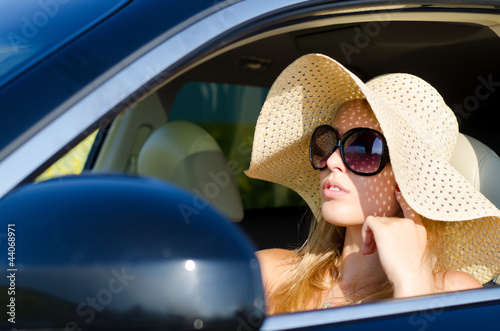 Photo: Woman driver in sunhat and sunglasses Woman driver in sunhat and sunglasses