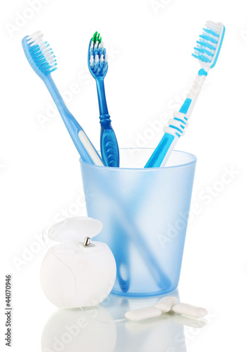 Photo: Toothbrushes, chewing gum and dental floss isolated on white Toothbrushes, chewing gum and dental floss isolated on white