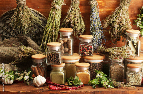 Photo: dried herbs, spices and and pepper, on wooden background dried herbs, spices and and pepper, on wooden background