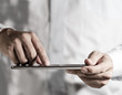 hand working on a digital tablet