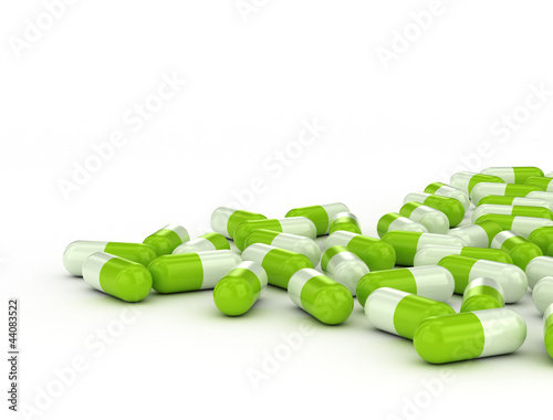 Photo: Green pills on white background Green pills on white background