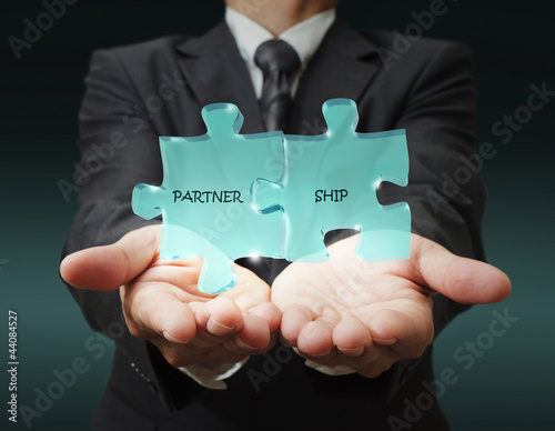 Photo: businessman shows "3d partnership" written puzzle pieces businessman shows "3d partnership" written puzzle pieces