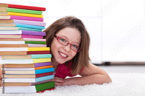 Photo: Young student with lots of books smiling Young student with lots of books smiling