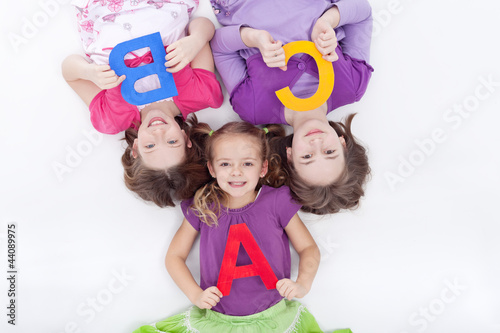 Photo: Girls holding A B C letters Girls holding A B C letters