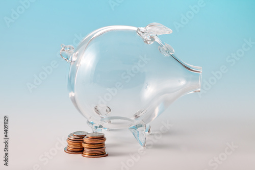 Photo: Glass piggy bank with coins Glass piggy bank with coins