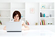 Beautiful young business woman using a laptop computer. Portrait