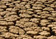 Cracked mud in dried up dam caused by drought