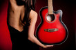Carmen beautiful woman with guitar on dark background