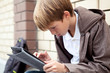 Photo: School teen with electronic tablet sitting School teen with electronic tablet sitting