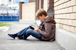 Photo: School teen with electronic tablet sitting School teen with electronic tablet sitting