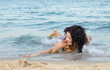 Woman frolicking in the surf