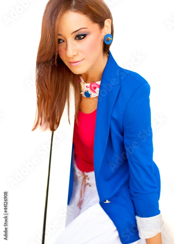 Photo: Beautiful young woman sitting over white background Beautiful young woman sitting over white background