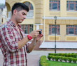 Foto: Man checking the back of his camera Man checking the back of his camera