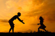Silhouettes of mother and daughter meeting on the meadow