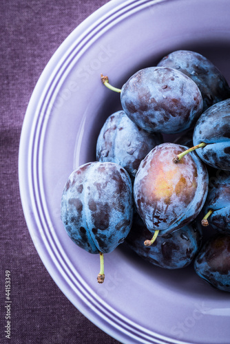 Photo: Fresh plums in a purple bowl Fresh plums in a purple bowl
