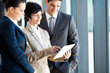 group of business people using tablet computer in office