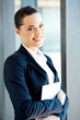 pretty young businesswoman holding tablet computer in office