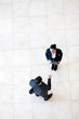 overhead view of businessman talking to businesswoman
