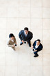 overhead view of colleagues having coffee break at work