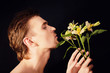 oung men sniffing bouquet of flowers