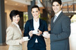 group of colleagues having coffee break at work
