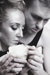 young couple in love with a white rose