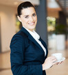 attractive modern businesswoman having coffee