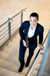 gorgeous young businesswoman walking up stairs