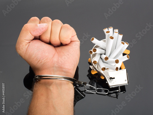 Photo: Hand locked to cigarettes Hand locked to cigarettes