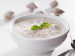 Bowl of new england clam chowder with basil garnish.