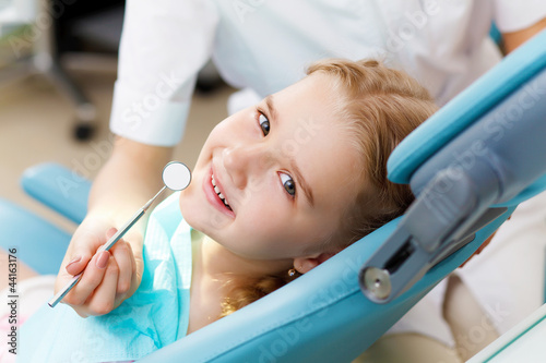 Photo: Little girl visiting dentist Little girl visiting dentist
