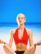 Foto: Woman doing yoga exercises or meditating Woman doing yoga exercises or meditating
