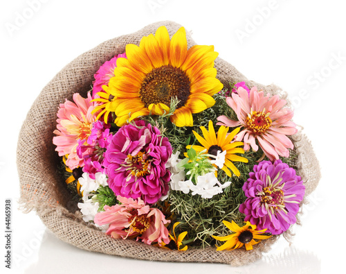 Photo: Beautiful bouquet of bright flowers in sacking isolated on Beautiful bouquet of bright flowers in sacking isolated on