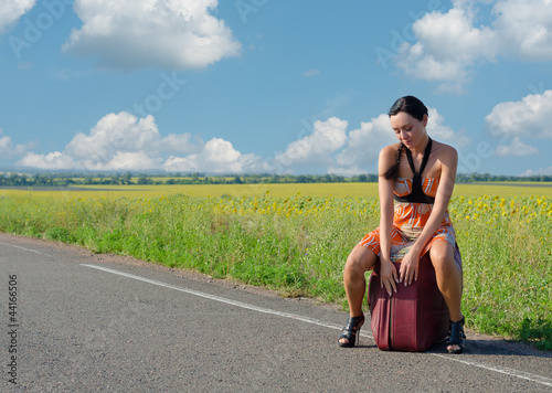 Photo: Dejected woman waiting for a lift Dejected woman waiting for a lift