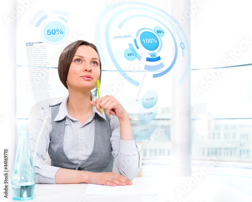 Photo: Businesswoman working with high tech type of modern interface at Businesswoman working with high tech type of modern interface at