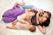 Breast feeding two little sisters twin girls at the same time.