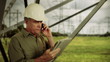 Electric Power Engineer on phone with electronic tablet