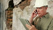 Construction engineer with cell phone and tablet