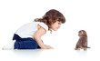 Funny child sitting on floor. Small kitten looking at girl.
