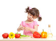 Little kid preparing vegetables for salad. Concept of healthy fo